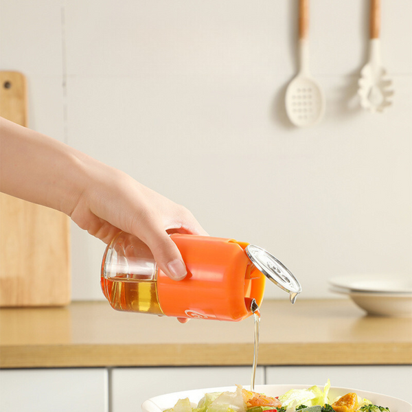 No-drip glass oil dispenser in orange, ideal for precise pouring while cooking - cupindy